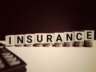 Financial Concept - INSURANCE text in vintage background. Stock photo.