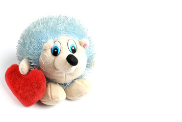Stuffed toy hedgehog with a plush heart, valentine's day card concept, copy space.