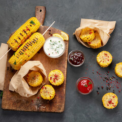 Grilled roasted sweet corn cobs with souces