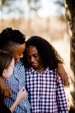 Siblings Embracing at Park in Chula Vista