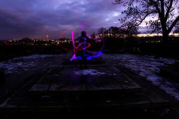 Silhouette Circus Model in Queens Park Bolton at Night in the Snow with Light Trails