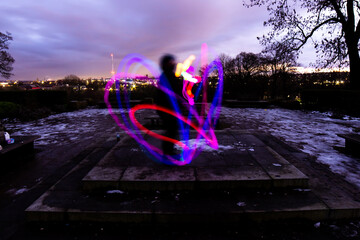 Silhouette Circus Model in Queens Park Bolton at Night in the Snow with Light Trails