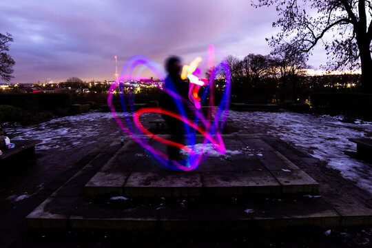 Silhouette Circus Model in Queens Park Bolton at Night in the Snow with Light Trails