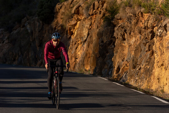 Man riding a bicycle on the mountain road from Benissa to Pinos.