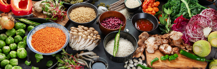 Asian raw vegan food, grain, seeds and vegetables on dark background - obrazy, fototapety, plakaty
