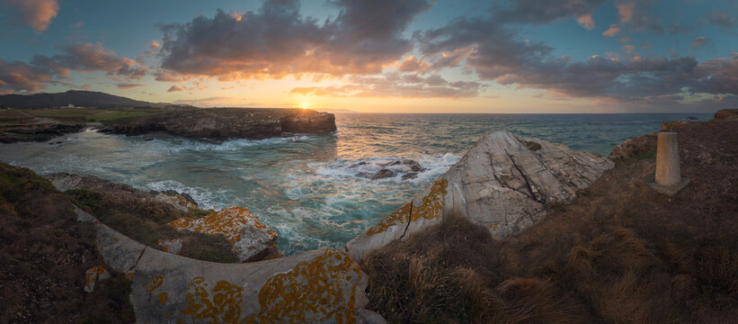 Panorama searching the colors of the sunset over a little beach - Powered by Adobe