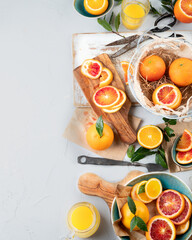 Oranges and juice in basket on light background