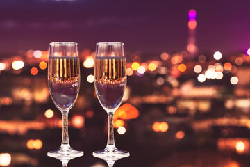 Two glasses of champagne on the background of the evening city