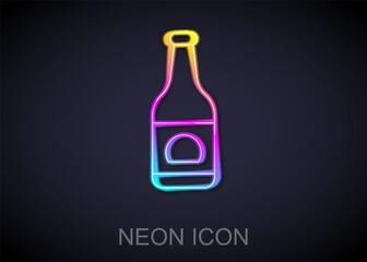 Glowing neon line Beer bottle icon isolated on black background. Vector.