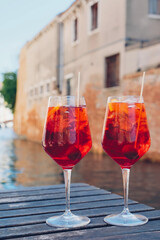 Two glasses of Spritz Veneziano cocktail served near the Venetian canal.  Popular italian summer...