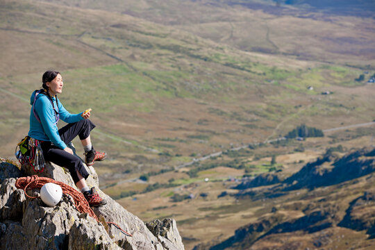 female rock climber enjoying a sandwich on Tryfan in North Wales