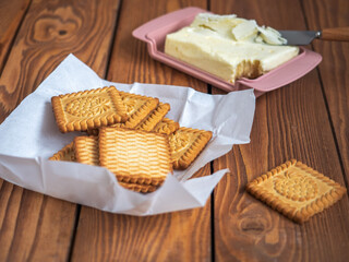 Lunch with cookies and butter in a butterdish, served on a wooden tray