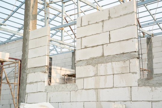 Aerated brick wall on site,lightweight cement brick wall and white lintel plaster to joint for reinforce at construction site.