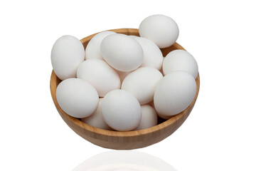 Many eggs lie in a wooden bowl on a white isolated background. - Powered by Adobe