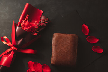 Top view a bouquet of roses and an empty wallet no money brown leather on black background