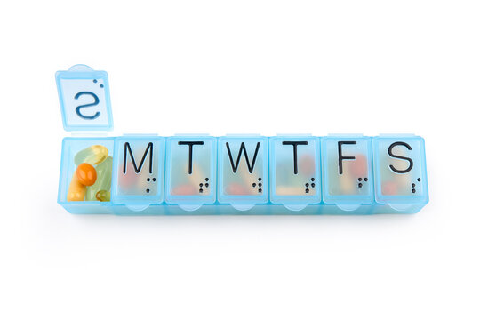 Daily portion of vitamins, drug medicines, tablets, dietary supplements in pill organizer or plactic pill box. A weekly container of tablets, vitamins. Nutritional supplements