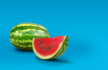 Ripe watermelon and slice isolated on blue background with copy space	
