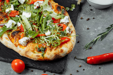 vegetarian pizza with cheese tomatoes and greens