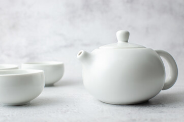 Tea time pot and white tea cup family on smoke background feel aromatic of hot drinks, Japanese and Chinese green refreshment. Theme of Family mother and children. Food and beverage concept