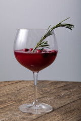 Cranberry juice in wine glass with fresh berries 