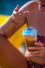 Lady drink frappe on the beach