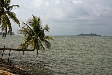 Fototapeta na wymiar View of the Singapore Strait from the Siloso Beach of Sentosa Island