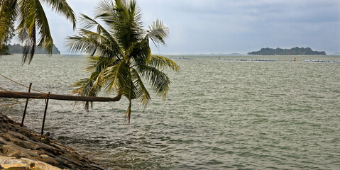 Naklejka na ściany i meble View of the Singapore Strait from the Siloso Beach of Sentosa Island