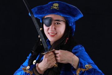 portrait of a beautiful girl pirate on a black background