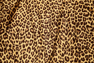 Leopard effect fabric pattern background sample. Leopard print seamless background.