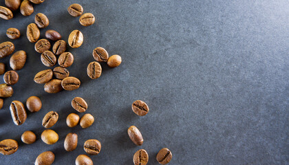 Coffee beans close-up on a gray stone background. Place for text.