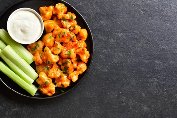 Foto op Canvas Cauliflower buffalo wings with celery and sauce © voltan