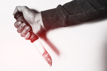 hand with knife and red glow concept crime