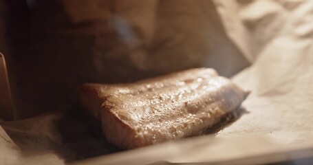 Salmon grilled in frying pen closeup footage