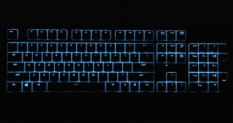 Illuminated keyboard glowing with RGB colors in the dark