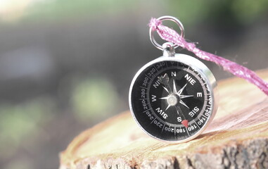Classic navigation compass on natural background as symbol of tourism with compass, travel with compass and outdoor activities with compass
