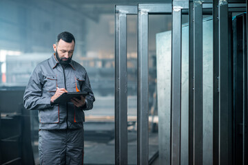 Worker with a digital tablet at the plant