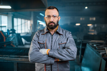 Metal industry worker at factory in work wear 