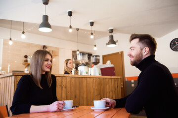 Young couple talking in a coffee shop