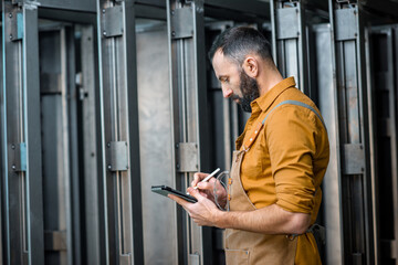 Worker with a digital tablet at the plant