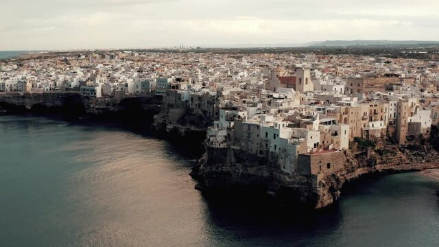 Aerial view on an ancient city coast with beach in Italy.