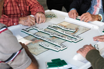 Elderly men play the domino game in the historic Domino Park in popular Little Havana in Miami, Florida - 409291835