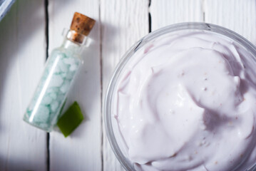 cosmetic cream product samples with hyacinth flowers on white wooden background