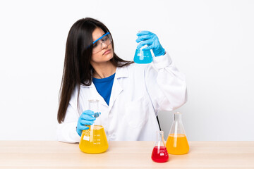 Young scientific woman in a table