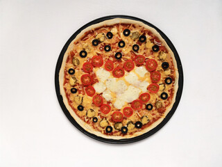 Pizza for Valentine's Day with red heart of cherry tomatoes. February 14 holiday concept