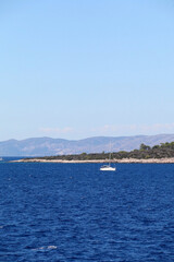 Obraz premium Sailing boat near island in Croatia. Beautiful Mediterranean landscape.