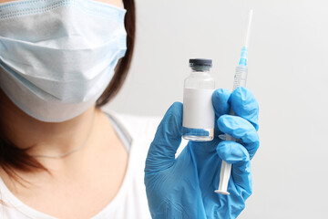 The doctor has a syringe and a vaccine in his hand. Vaccinations.