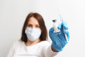 The doctor has a syringe and a vaccine in his hand. Vaccinations.
