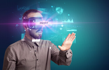 Businessman looking through Virtual Reality glasses with PROFIT inscription, new business concept