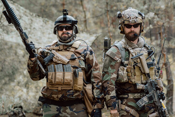 Portrait of a middle-aged bearded soldiers in a Woodland military uniform and helmet, with...