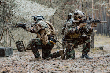 Squad of Four Fully Equipped Soldiers in Camouflage on a Reconnaissance Military Mission, Aiming...